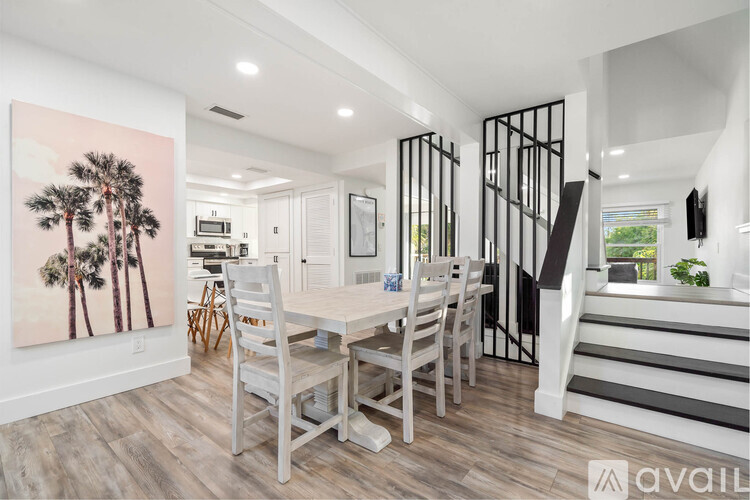 A dining room with a wooden table and chairs.