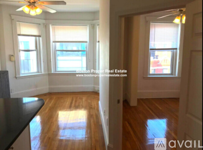 A room with wooden floors and a ceiling fan.