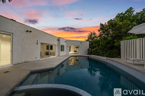 A modern house with a pool in the backyard.
