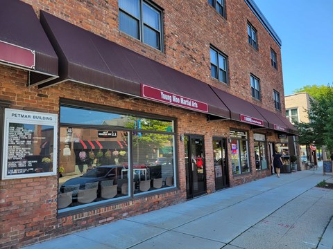 A brick building with a red awning and a sign that says "Young Mortuary.".
