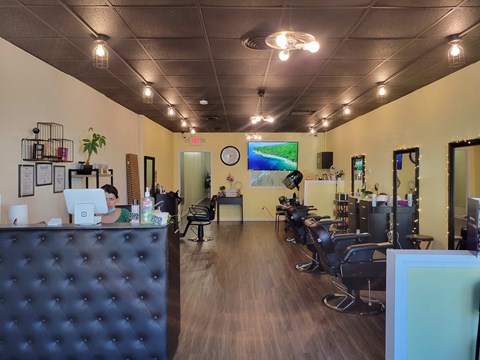 A salon with a person working on a computer.