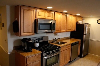 A kitchen with wooden cabinets and stainless steel appliances.