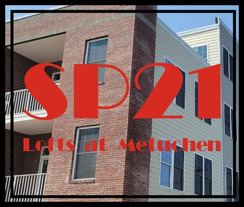A red text SP21 is written on a background of a building.