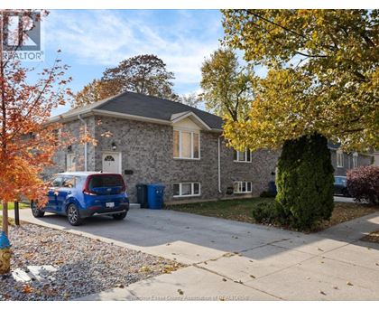 A house with a blue car parked in front.