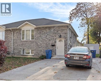 A house with a car parked in front of it.