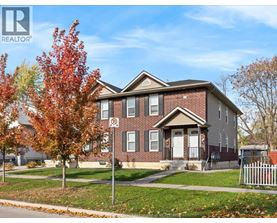 A house with a REALTOR® sign in front of it.
