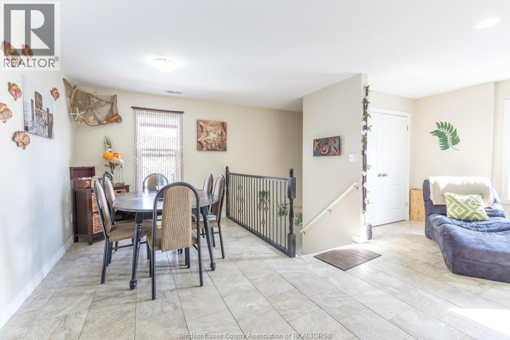 A dining room with a table set for six with chairs around it.