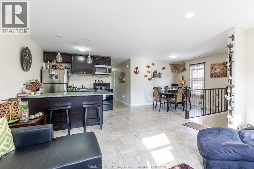 A well-lit kitchen with a bar area and a dining table.