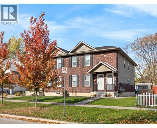 A house with a REALTOR® sign in front of it.