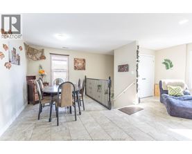 A dining room with a table set for six with chairs around it.