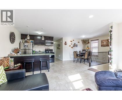 A well-lit kitchen with a bar area and a dining table.