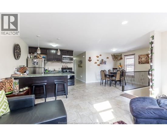 A well-lit kitchen with a bar area and a dining table.