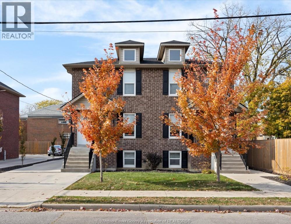 A house with a tree in front of it.
