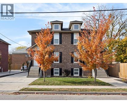 A house with a tree in front of it.