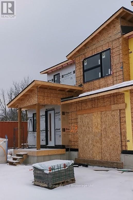 A house under construction with a partially built roof and walls.