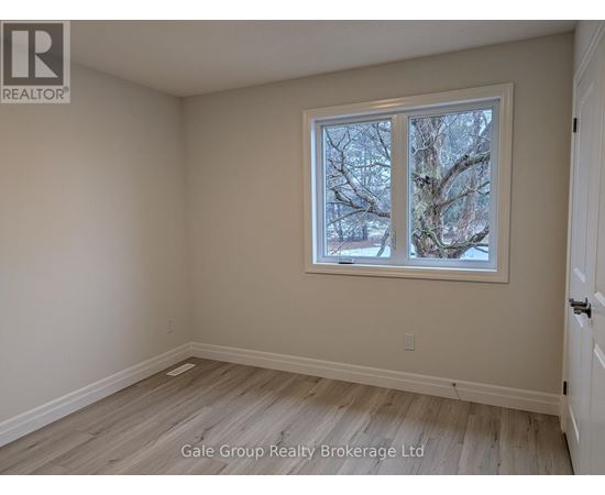 A room with a window showing trees outside.