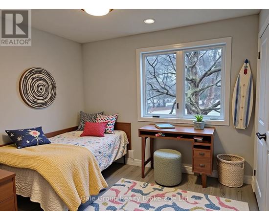 A bedroom with a bed, desk, and window.