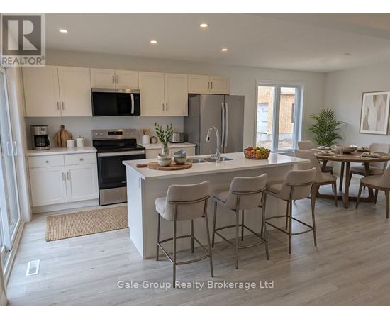 A modern kitchen with white cabinets and a central island.
