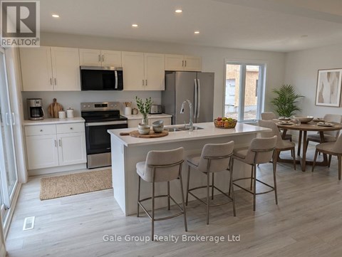 A modern kitchen with white cabinets and a central island.