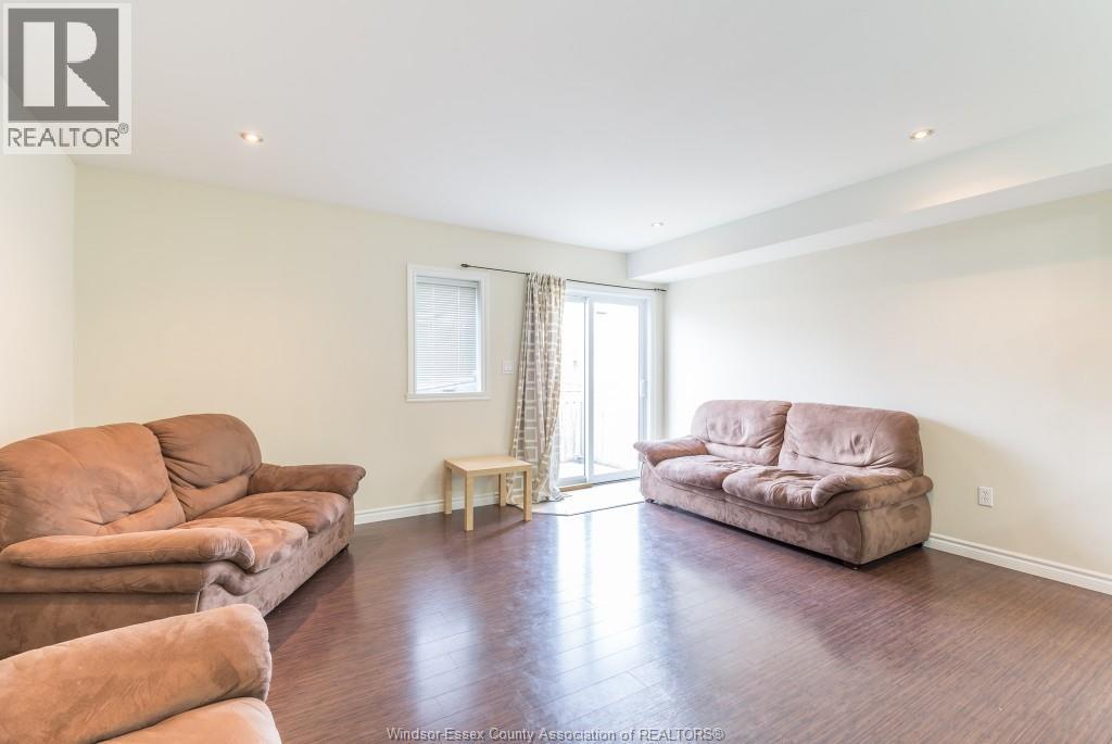 A living room with a couch, chair, and table.