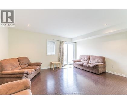 A living room with a couch, chair, and table.
