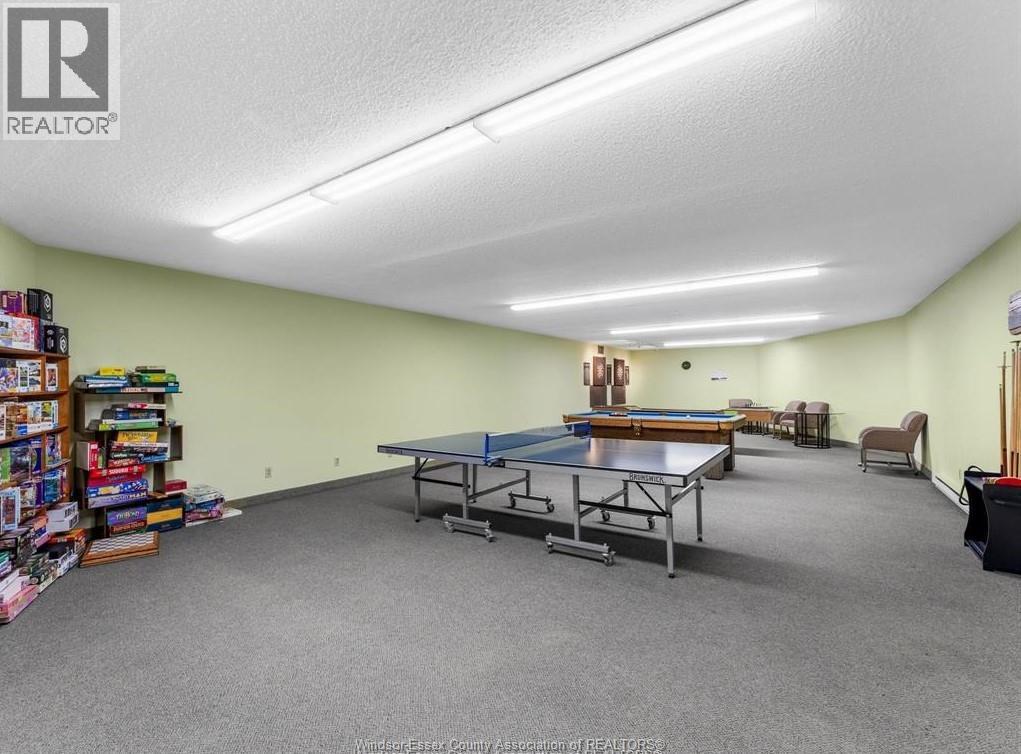 A room with a pool table and a shelf with toys.