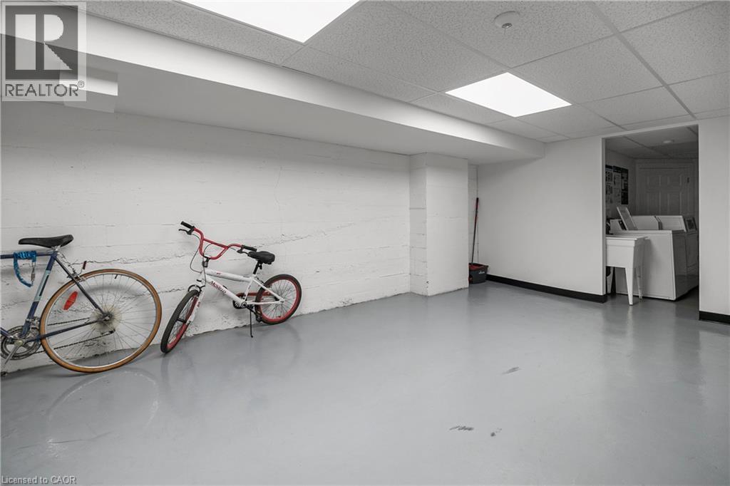 Two bicycles are leaning against a wall in a spacious room.