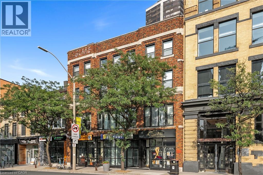A street view of a city with a building that has a sign that says "REALTOR".