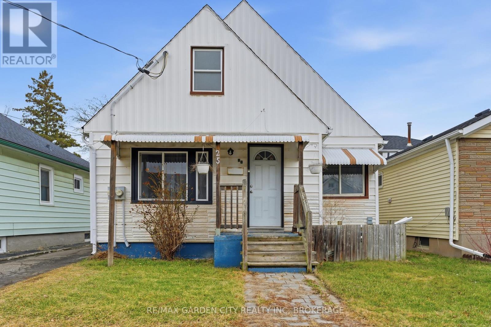 A white house with a blue door and a small porch.
