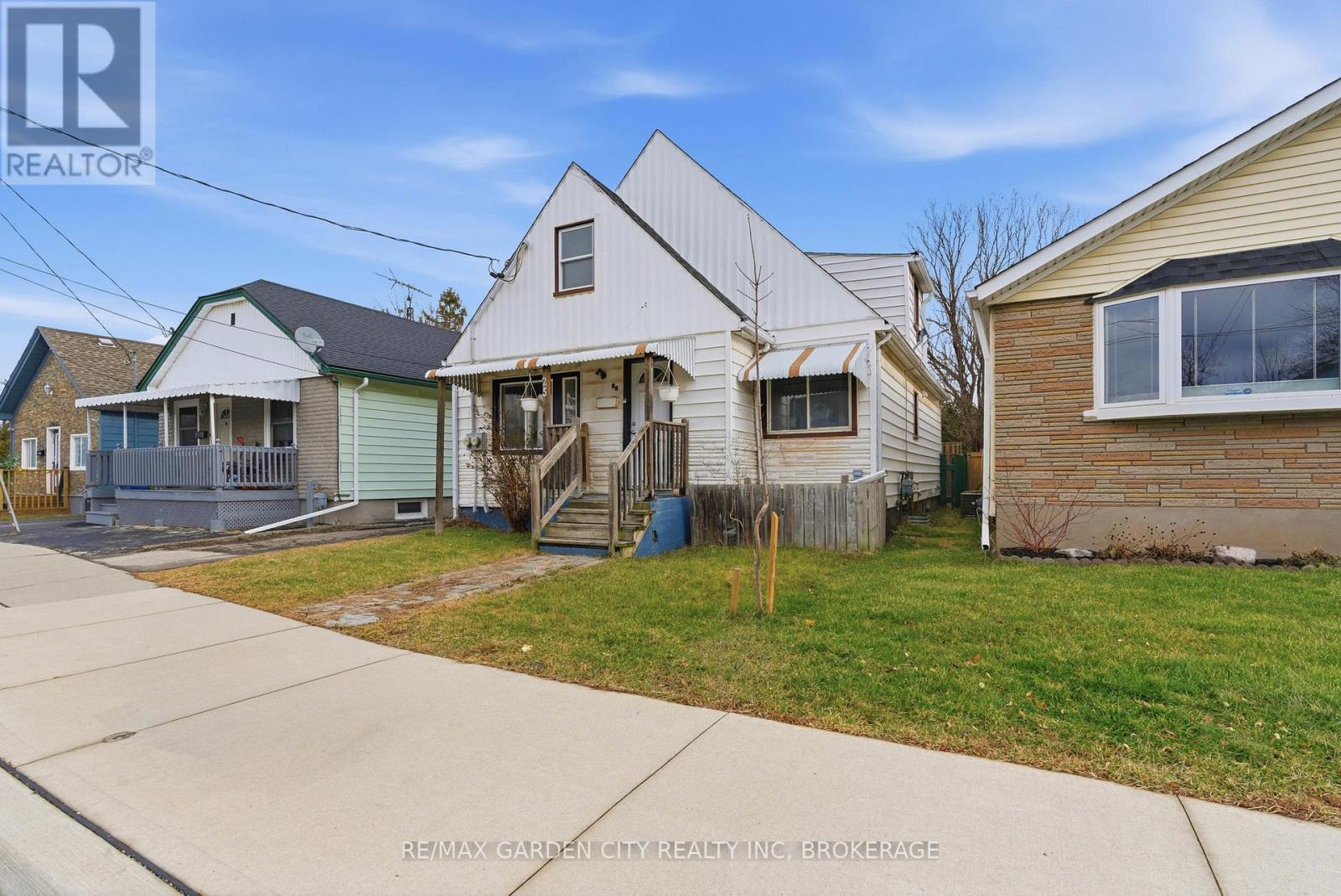 A house with a white exterior is for sale.