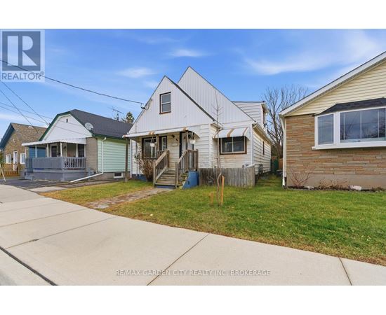 A house with a white exterior is for sale.