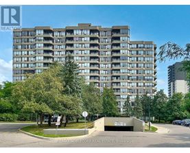 A large apartment building with a parking lot in front.