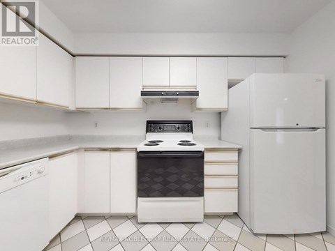 A white kitchen with a black stove top oven.
