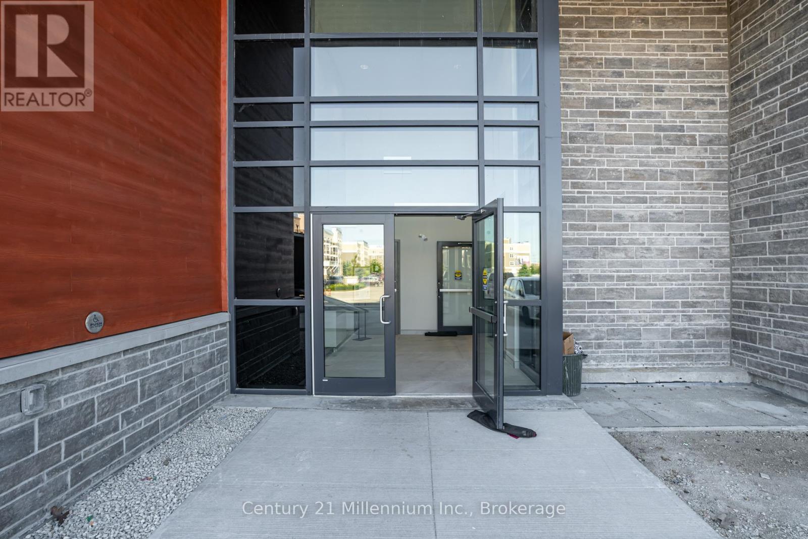A glass door entrance to a building with a sign that says REALTOR.