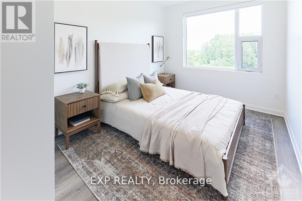 A bedroom with a large bed, a nightstand, and a rug.