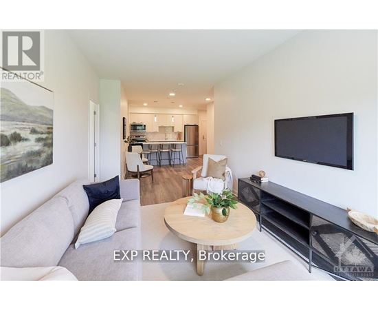 A living room with a grey couch and a wooden coffee table.