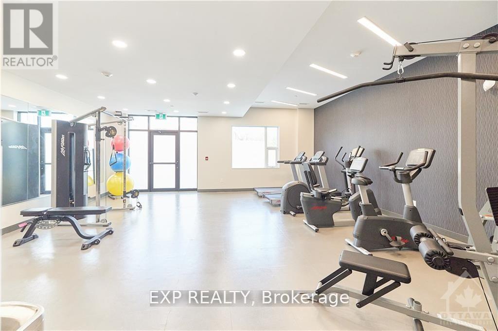 A gym with a variety of exercise equipment including treadmills, stationary bikes, and weight machines.