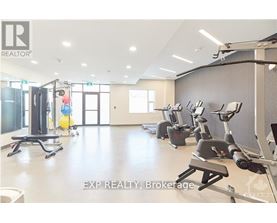 A gym with a variety of exercise equipment including treadmills, stationary bikes, and weight machines.