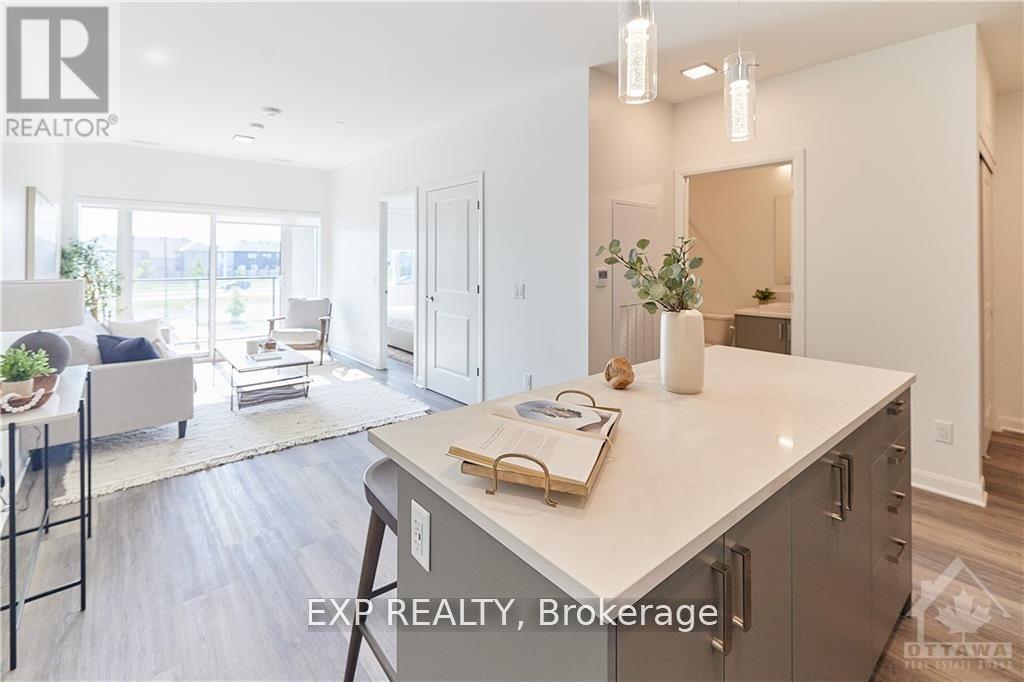 A modern kitchen with a large island and a dining area with a table and chairs.