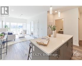 A modern kitchen with a large island and a dining area with a table and chairs.