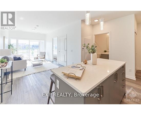 A modern kitchen with a large island and a dining area with a table and chairs.