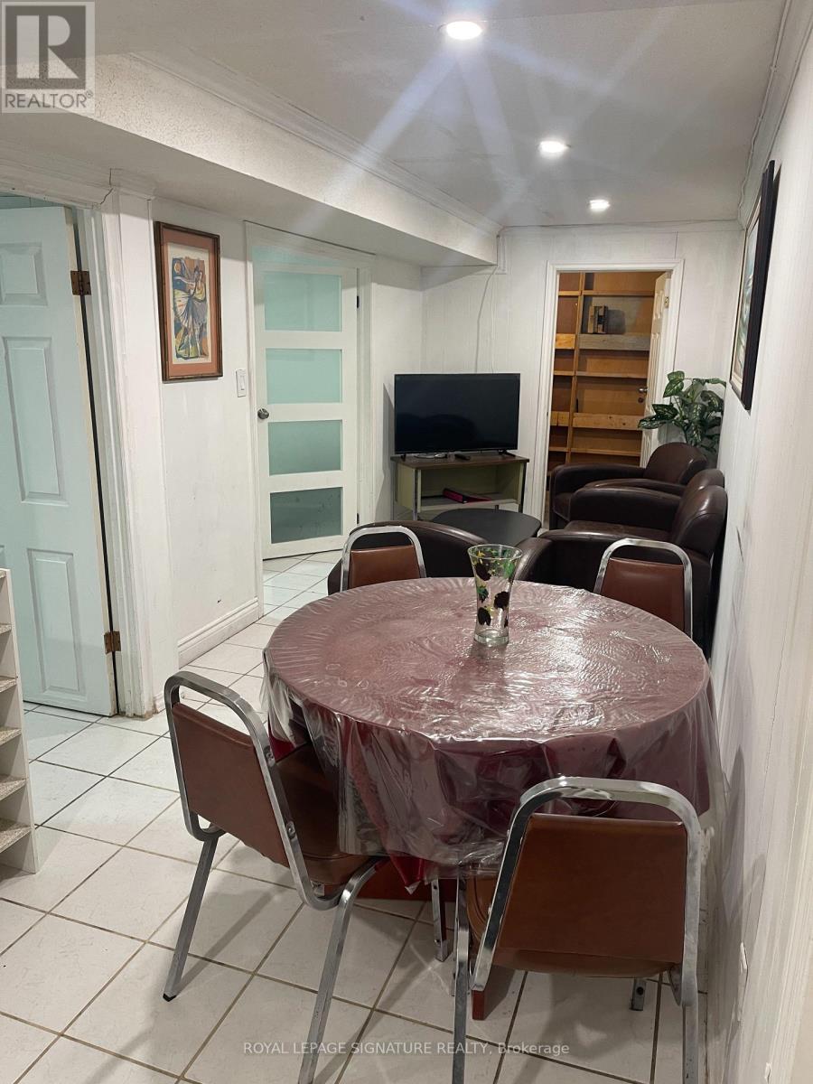 A dining room with a table set for four.