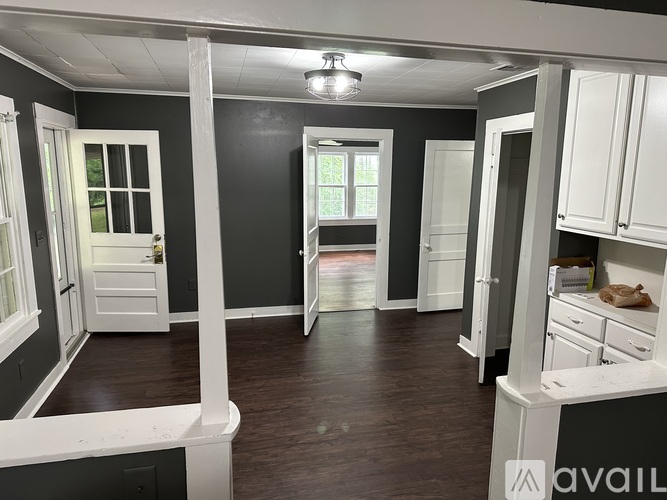 A room with white cabinets and a window.