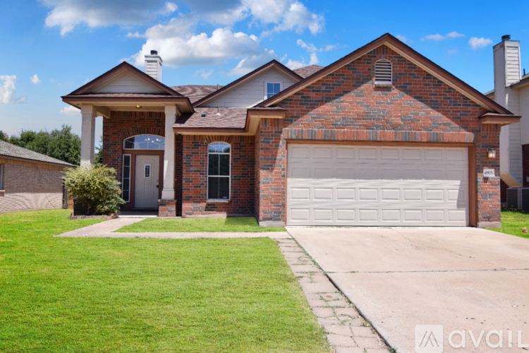 A house with a brick facade and a white garage door.