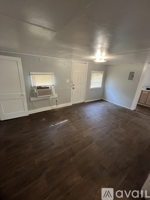 A room with wooden floors and white walls.