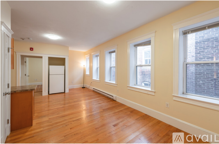 A room with wooden floors and white walls.