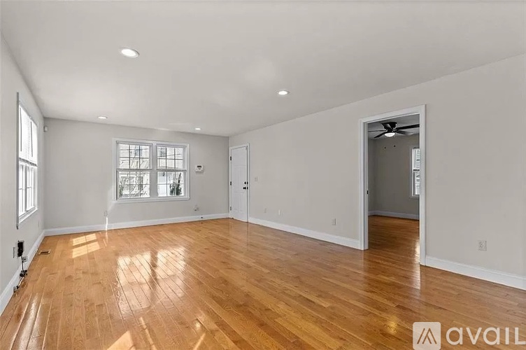 A room with a staircase and a white door.