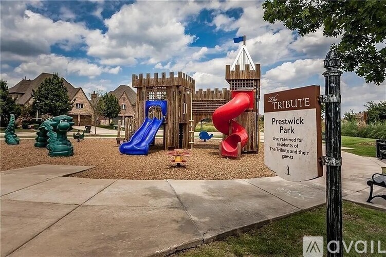 A playground with a sign that says "Tribute Prestwick Park".