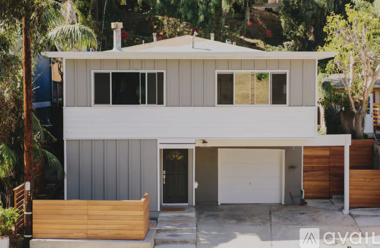 A modern house with a garage is for sale.
