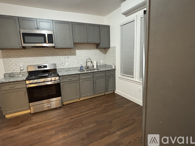 A room with wooden floors and white walls.